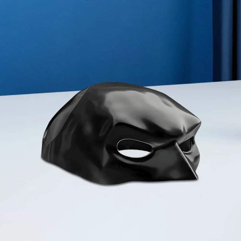 Black mask on a white surface with a blue background