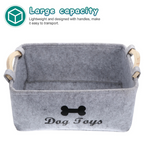 Gray storage basket with wooden handles labeled 'Dog Toys' on a white background