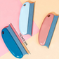 Three相见器 (separating tools) with blue and pink handles on a colorful background