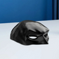 Black mask on a white surface with a blue background