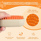 Steam brush for cats and dogs with silicone round brush head on an orange background