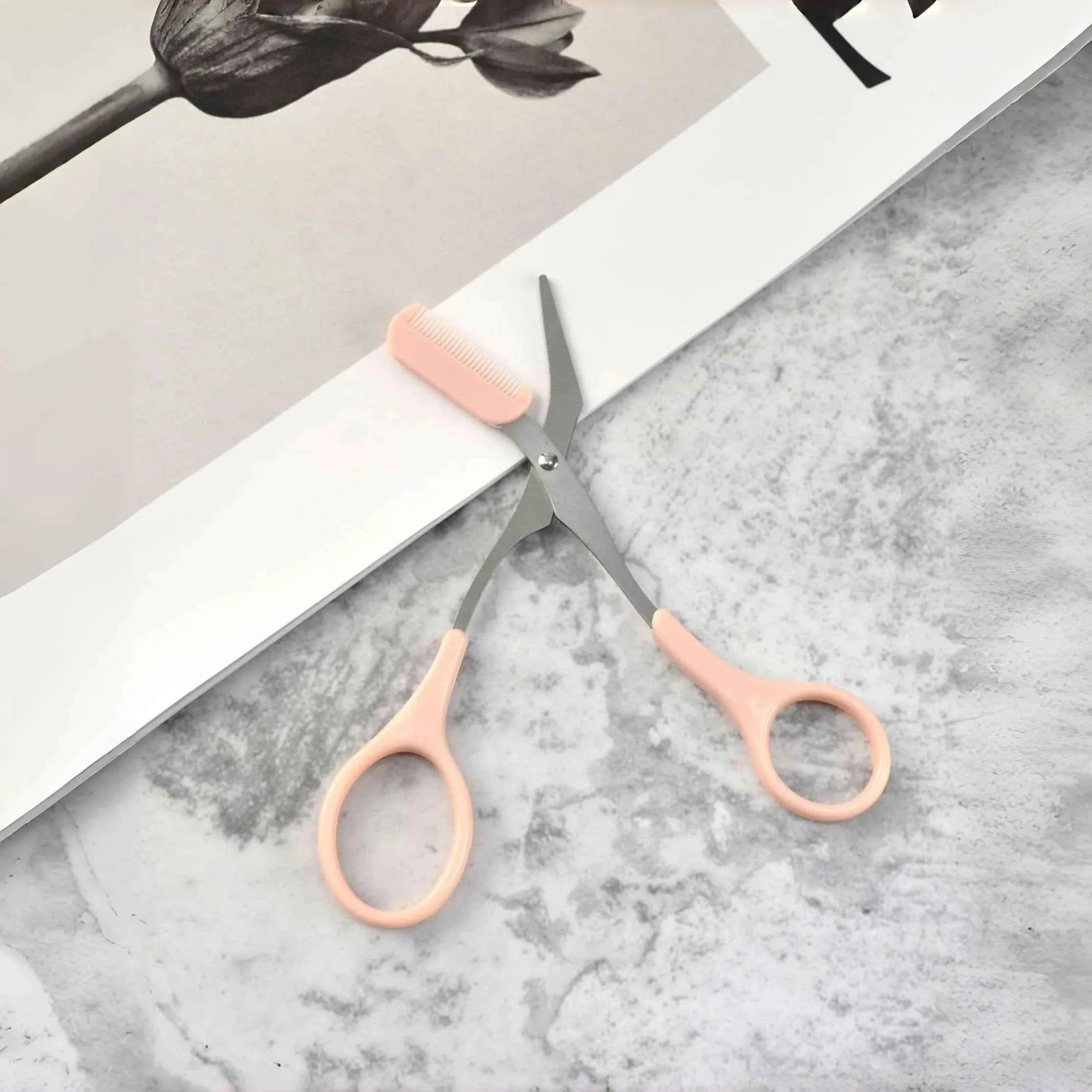 Pink eyebrow trimming scissors with built-in comb - stainless steel, precise grooming tool, creating perfect eyebrows