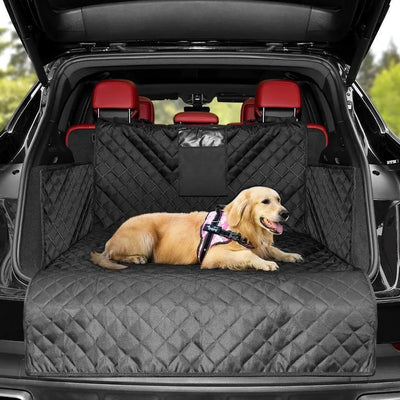 Dog sitting on a black quilted car seat cover in a vehicle