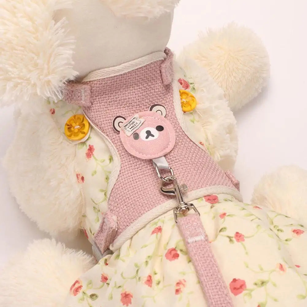 Pink dog harness with bear design on a floral-patterned teddy bear.