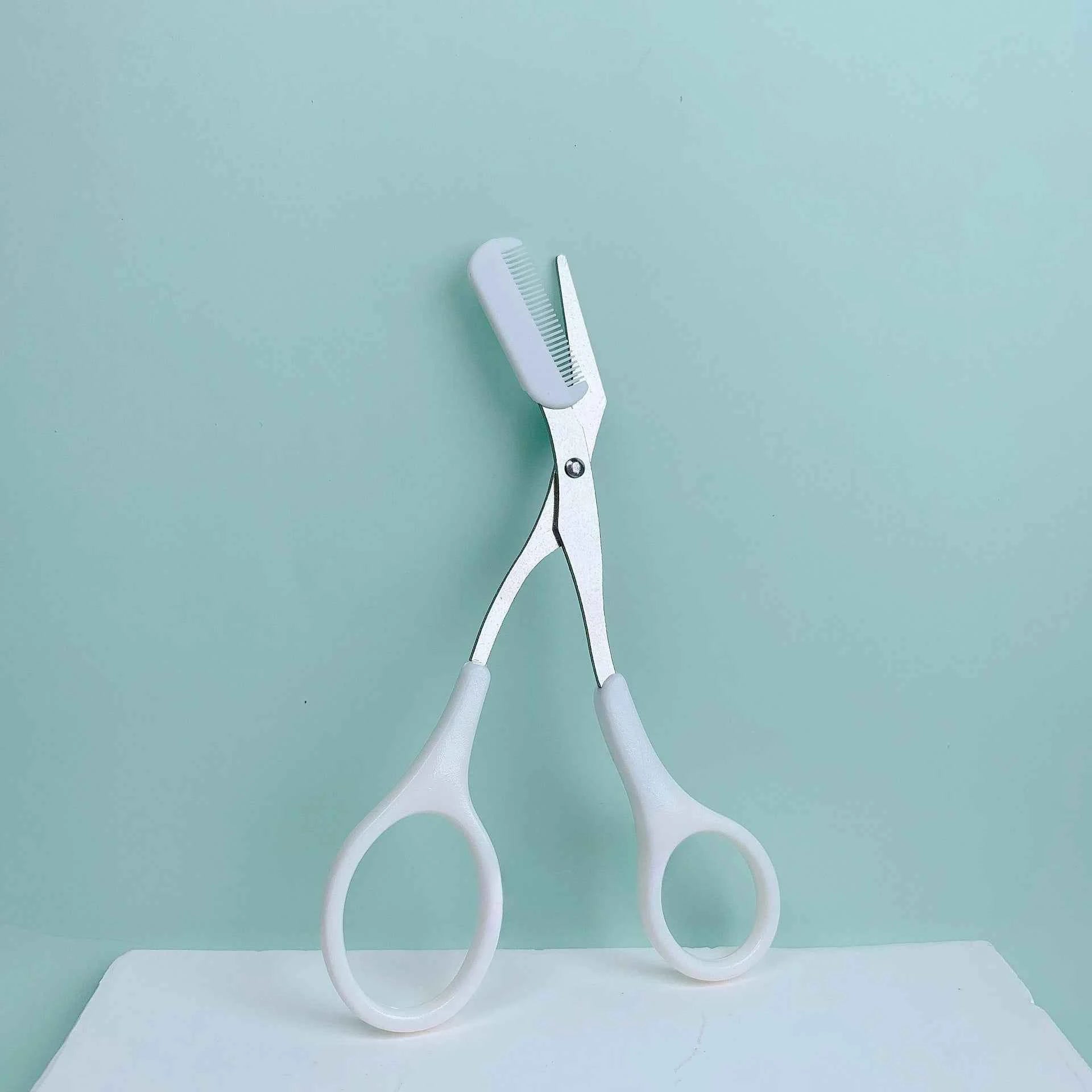 Pink eyebrow trimming scissors with built-in comb - stainless steel, precise grooming tool, creating perfect eyebrows
