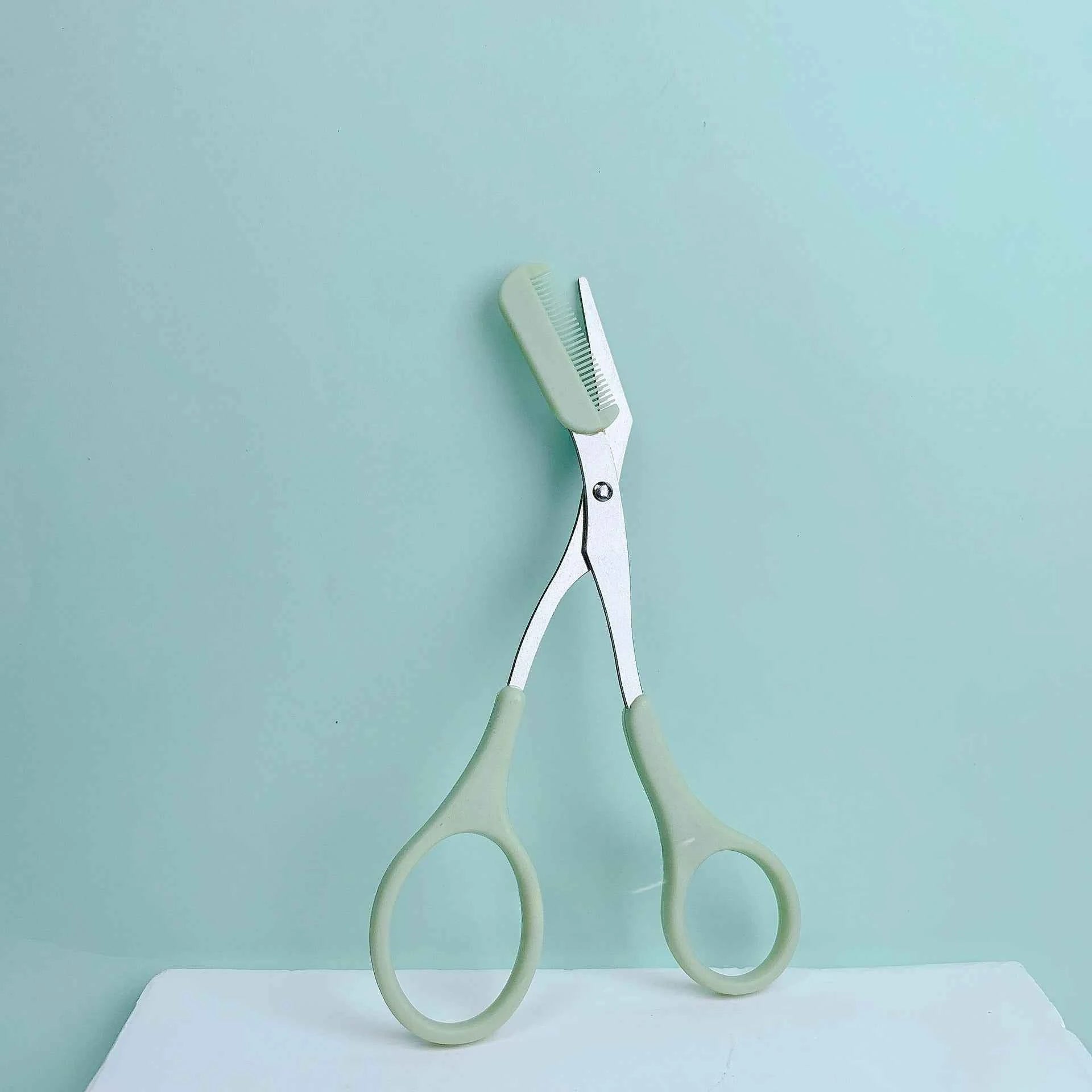 Pink eyebrow trimming scissors with built-in comb - stainless steel, precise grooming tool, creating perfect eyebrows